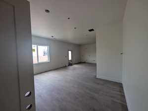 Spare room featuring wood finished floors and baseboards
