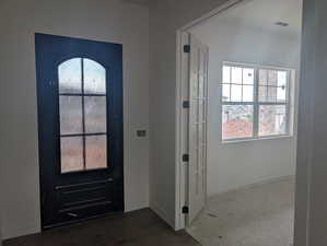 Doorway to outside featuring baseboards