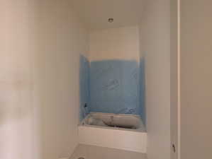 Bathroom featuring a bath and tile patterned floors