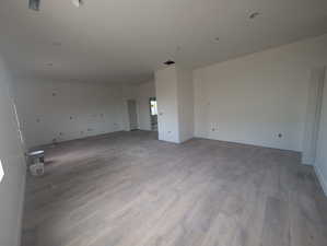 Spare room with light wood-style floors and baseboards