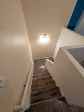 Stairs featuring wood finished floors