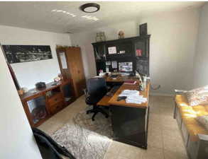 Office space featuring light tile patterned floors and baseboards