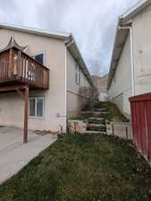 View of home's exterior featuring a lawn, stucco siding, a patio, and a vegetable garden