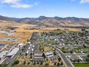 Aerial overview of property's location with a mountain backdrop and nearby suburban area
