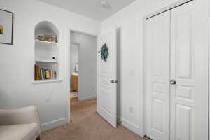 Sitting room with light carpet and baseboards