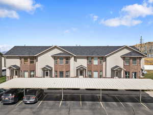 View of building exterior with covered parking