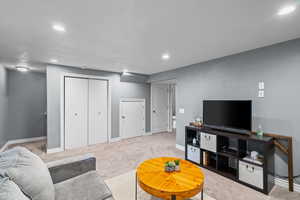 Carpeted living area featuring recessed lighting