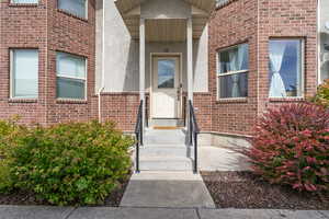Entrance to property with brick siding