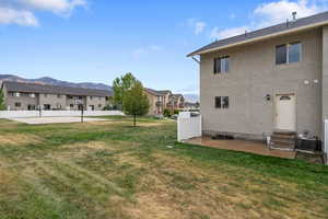 View of yard featuring a mountain view, a patio area, entry steps, and a residential view