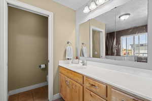 Bathroom with vanity and light tile patterned flooring