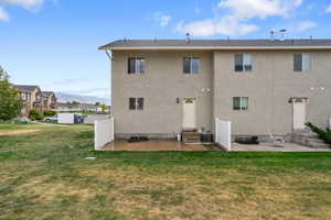 Back of house featuring a patio, stucco siding, a mountain view, and entry steps