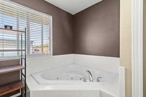 Full bathroom featuring a tub with jets