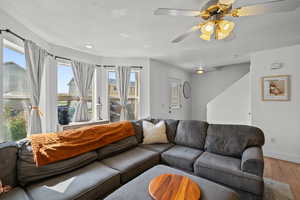 Living area featuring wood finished floors and a ceiling fan
