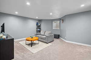 Living area featuring light carpet and recessed lighting