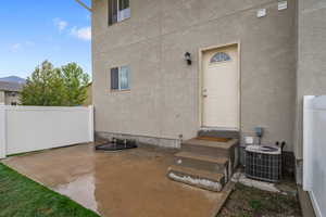 Property entrance featuring stucco siding and a patio