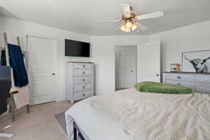 Bedroom featuring light colored carpet and a ceiling fan