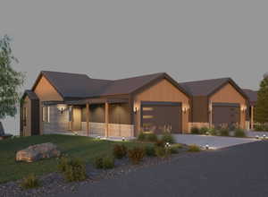 View of front of property featuring an attached garage, a front yard, concrete driveway, stone siding, and a metal roof