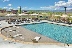Community pool featuring a gazebo, a patio, and a mountain view
