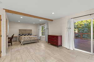 Bedroom featuring beamed ceiling, recessed lighting, access to outside, and wooden walls