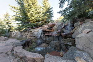 View of yard with a garden pond