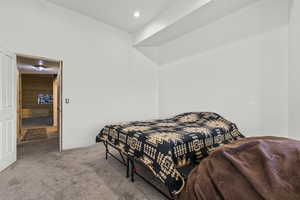 Carpeted bedroom with wood walls