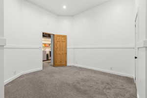 Spare room featuring carpet floors, ornamental molding, and washing machine and clothes dryer