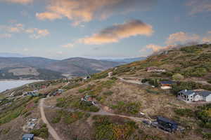 Aerial view of property and surrounding area featuring a water and mountain view