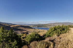 View of mountain backdrop featuring a nearby body of water
