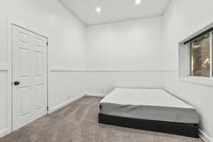Carpeted bedroom with baseboards and recessed lighting