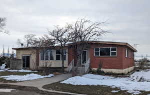 Bungalow-style house featuring brick siding