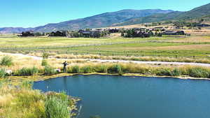 Aerial view of sparsely populated area with a mountain backdrop and agricultural land