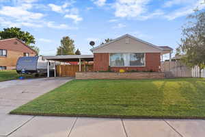 View of front of home featuring driveway and brick siding