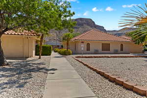 Mediterranean / spanish home featuring stucco siding, a mountain view, and a tiled roof
