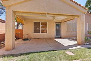 Rear view of property featuring a patio, stucco siding, and ceiling fan