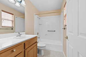 Full bathroom with bathtub / shower combination, vanity, and light tile patterned flooring