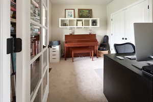 Home office featuring light colored carpet