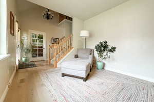 Living area with wood-type flooring and stairway