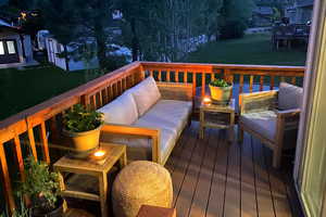 Wooden terrace featuring a lawn and an outdoor living space