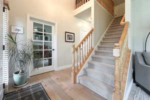 Stairway featuring wood finished floors and baseboards