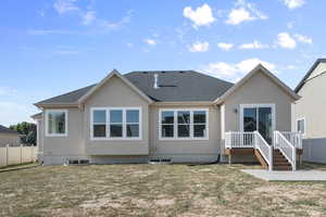 Rear view of house with stucco siding and a shingled roof
