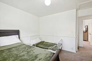 Bedroom with carpet flooring and baseboards