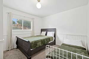 Carpeted bedroom featuring baseboards