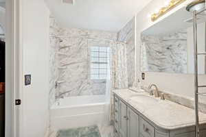 Bathroom featuring shower / tub combo and vanity