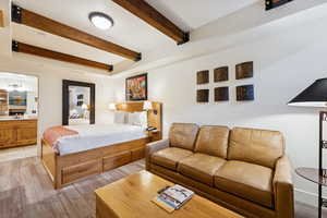 Bedroom featuring beam ceiling and ensuite bathroom