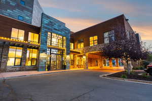 View of property at dusk