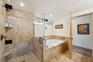Full bathroom with a stall shower, a bath, tile patterned flooring, and recessed lighting