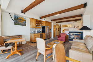 Dining room with beam ceiling, a fireplace, and light tile patterned floors