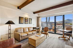 Living room featuring a mountain view, beam ceiling, and recessed lighting