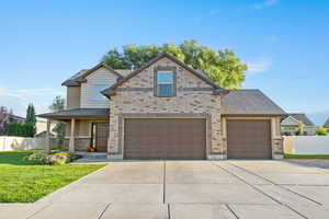 View of front of property featuring concrete driveway and a porch