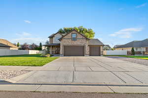 Traditional-style home with driveway, covered porch, brick siding, and a garage